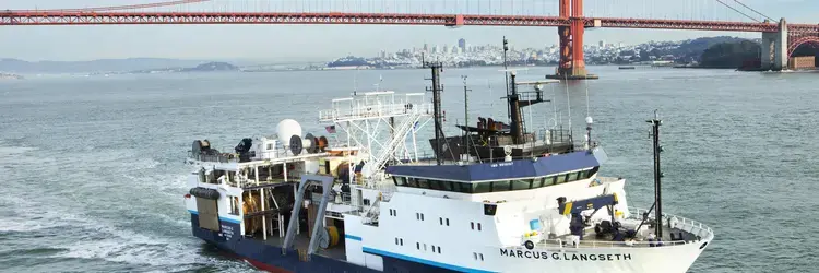 RV Langseth underway in green water in front of the Golden Gate Bridget