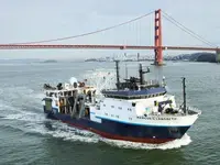 RV Langseth underway in green water in front of the Golden Gate Bridget