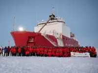 USCGC Healy in the ice, with crew in front of ship