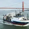 RV Langseth underway in green water in front of the Golden Gate Bridget