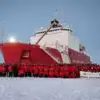 USCGC Healy in the ice, with crew in front of ship