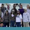 Photo of StemSEAS Participants on a ship with logo in upper right corner